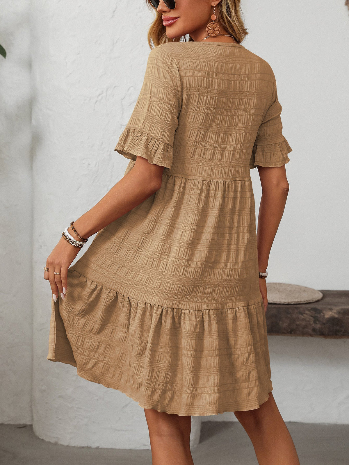 Margo & Main – Vianne tan textured tiered short-sleeve dress, front view of the tiered hem with hands at the sides, US women's sizes