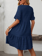 Margo & Main – Vianne navy blue textured tiered short-sleeve dress, front view of the tiered hem with hands at the sides, US women's sizes