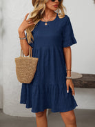 Margo & Main – Vianne navy blue textured tiered short-sleeve dress, front view styled with sunglasses and a straw tote, US women's sizes