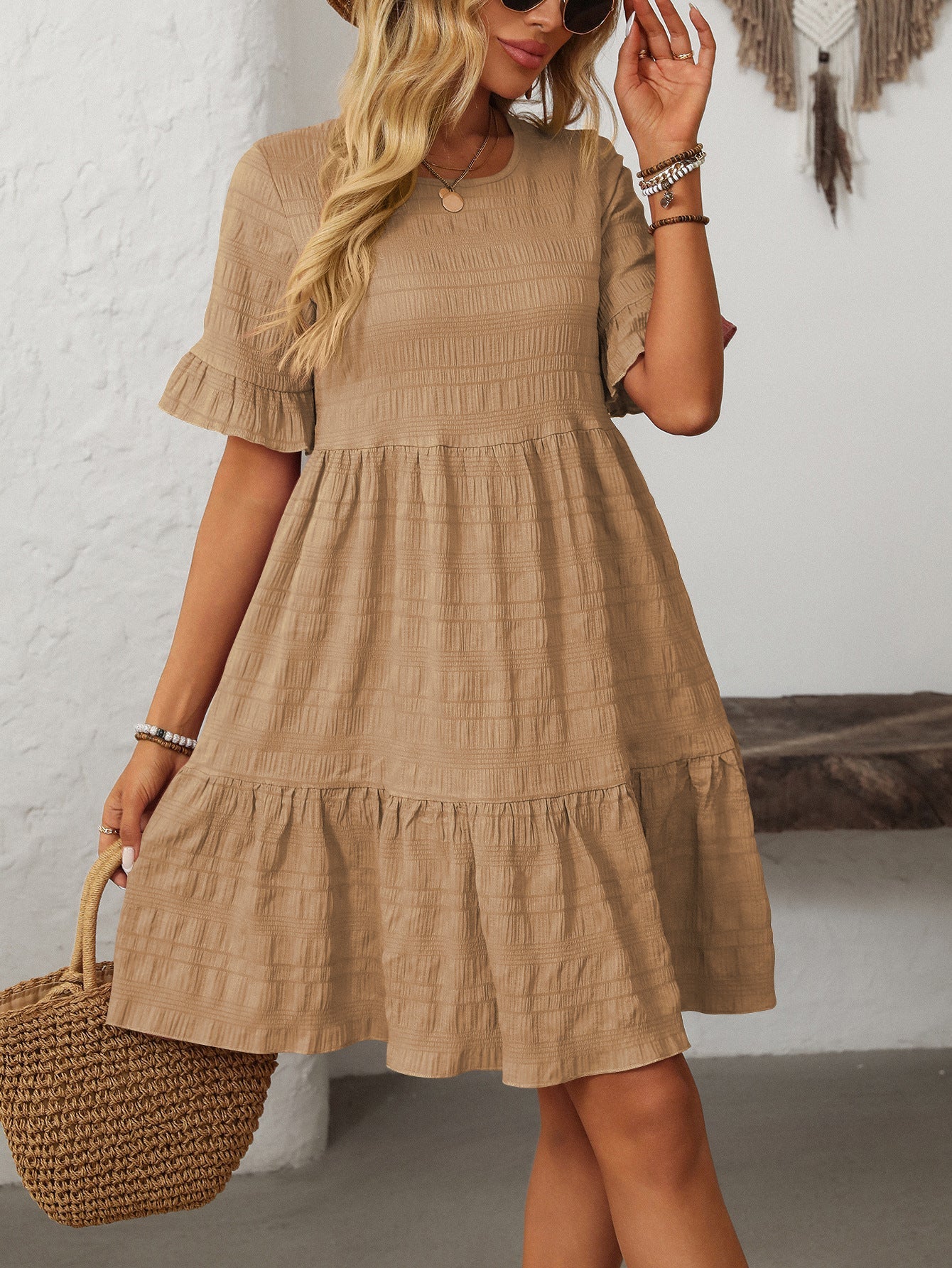 Margo & Main – Vianne tan textured tiered short-sleeve dress, front view with a straw tote on the arm, US women's sizes