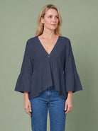 Melba Lane - navy bell sleeve V neck blouse, full length studio view, AU women's sizes