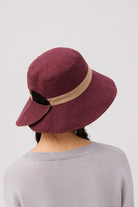 Margo & Main – Sabella reversible sun hat turned to its burgundy side with a tan band, back view showing the adjustable tab