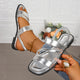 Melba Lane - silver cross strap flat sandals held in hand, angled view, AU women's sizes